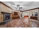 Spacious living room boasting a fireplace, tiled floors, and access to a wet bar at 1235 E Clearview Dr, Casa Grande, AZ 85122