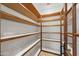Spacious pantry with custom wood shelving and a marble-look floor, great for storage and organization at 1235 E Clearview Dr, Casa Grande, AZ 85122
