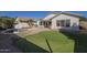 Spacious backyard with artificial turf, pool, and privacy wall, perfect for relaxation and recreation at 12901 W Wilshire Dr, Avondale, AZ 85392