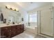 Bright bathroom with double sink vanity, soaking tub, and walk-in shower at 12901 W Wilshire Dr, Avondale, AZ 85392