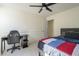 Functional bedroom with a ceiling fan, desk, and bed, offering a comfortable setup at 12901 W Wilshire Dr, Avondale, AZ 85392