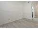 Empty room with neutral color palette, laminate floors and a glimpse of hallway at 12901 W Wilshire Dr, Avondale, AZ 85392