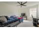 Comfortable bedroom setup with a ceiling fan, bed, desk, and TV for relaxation at 12901 W Wilshire Dr, Avondale, AZ 85392