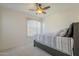 Bright bedroom with a ceiling fan and patterned bedding, creating a calm retreat at 12901 W Wilshire Dr, Avondale, AZ 85392