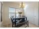 Bright dining area with large window and dark wood table with bench at 12901 W Wilshire Dr, Avondale, AZ 85392
