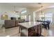 Open concept living area with kitchen island, dining space, and comfortable seating at 12901 W Wilshire Dr, Avondale, AZ 85392