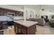 Bright, open-concept living area with kitchen island, dining space, and comfortable seating at 12901 W Wilshire Dr, Avondale, AZ 85392