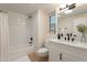 Bright bathroom featuring a shower over tub with subway tile and a vanity with white cabinets at 12946 W Maplewood Dr, Sun City West, AZ 85375