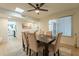 Bright dining room featuring a modern light, wood flooring, and comfortable seating at 12946 W Maplewood Dr, Sun City West, AZ 85375