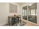 Bright kitchen nook, with modern abstract art and a sliding glass door leading to a screened porch at 12946 W Maplewood Dr, Sun City West, AZ 85375