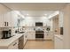 Modern kitchen featuring white cabinets, quartz countertops, and stainless steel appliances at 12946 W Maplewood Dr, Sun City West, AZ 85375