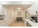 Updated kitchen features stainless appliances, white cabinets, quartz countertops, and a view into a casual dining nook at 12946 W Maplewood Dr, Sun City West, AZ 85375