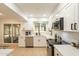 Bright kitchen with quartz countertops, stainless steel appliances and a view into the casual dining area at 12946 W Maplewood Dr, Sun City West, AZ 85375