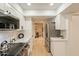 The modern kitchen features stainless appliances, sleek white cabinets, quartz countertops, and hardwood style floors at 12946 W Maplewood Dr, Sun City West, AZ 85375