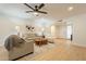 Inviting living room featuring modern ceiling fan, wood floors, and neutral decor at 12946 W Maplewood Dr, Sun City West, AZ 85375