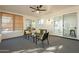 Beautiful sunroom features a ceiling fan and comfortable seating with lots of natural light at 12946 W Maplewood Dr, Sun City West, AZ 85375
