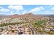 Scenic aerial view of a neighborhood, golf course, and mountains under a blue sky with clouds at 1302 E Voltaire Ave, Phoenix, AZ 85022