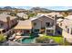 Aerial view of a home with a pool, covered patio, second story balcony, and solar panels at 1302 E Voltaire Ave, Phoenix, AZ 85022