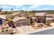 Aerial view showcasing a three-car garage, lush landscaping, and tile roof at 1302 E Voltaire Ave, Phoenix, AZ 85022