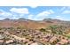 Panoramic aerial view of a residential neighborhood surrounded by mountains and a golf course at 1302 E Voltaire Ave, Phoenix, AZ 85022
