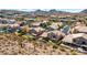 Beautiful aerial view showcasing homes with private pools and green lawns set against a mountain backdrop at 1302 E Voltaire Ave, Phoenix, AZ 85022