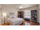 Bedroom with wood floors, ceiling fan, and stylish shelving at 1302 E Voltaire Ave, Phoenix, AZ 85022