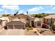 Inviting two-story home features a well-manicured front yard and a two-car garage, creating a warm curb appeal at 1302 E Voltaire Ave, Phoenix, AZ 85022