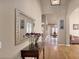 Inviting foyer with hardwood floors, elegant mirror, and seamless flow to other living spaces at 1302 E Voltaire Ave, Phoenix, AZ 85022