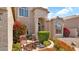 Charming home entrance with stone pathway and decorative landscaping, complemented by a cozy seating area at 1302 E Voltaire Ave, Phoenix, AZ 85022