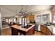Spacious kitchen featuring an island cooktop, updated appliances, and an eat-in dining area at 1302 E Voltaire Ave, Phoenix, AZ 85022