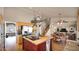 Open kitchen with a center island, updated appliances, and seamless flow into the dining area at 1302 E Voltaire Ave, Phoenix, AZ 85022