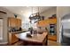 Well-lit kitchen featuring wood cabinets, granite counters, and stainless steel double ovens at 1302 E Voltaire Ave, Phoenix, AZ 85022