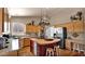 Modern kitchen with wood cabinets, granite countertops, stainless steel appliances and a breakfast bar at 1302 E Voltaire Ave, Phoenix, AZ 85022