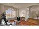 Bright living room features hardwood floors, large windows, and comfortable seating, perfect for relaxation and entertaining at 1302 E Voltaire Ave, Phoenix, AZ 85022