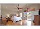 Bright main bedroom with wood floors, vaulted ceilings, and sliding door to a deck at 1302 E Voltaire Ave, Phoenix, AZ 85022
