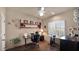 Bright office space with a desk, chair, shelving, and an exercise bike at 1302 E Voltaire Ave, Phoenix, AZ 85022