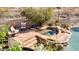 Inviting backyard pool and spa featuring natural rock surround and desert landscaping at 1302 E Voltaire Ave, Phoenix, AZ 85022