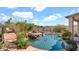 Relaxing backyard featuring a pool with a waterfall, mature landscaping, and a seating area at 1302 E Voltaire Ave, Phoenix, AZ 85022