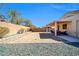 View of the backyard with a covered patio and a blank canvas for landscaping at 13534 W Young St, Surprise, AZ 85374