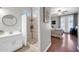 Bright bathroom featuring walk-in shower, modern fixtures, and round mirror at 13534 W Young St, Surprise, AZ 85374