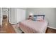 Bedroom featuring a bed with a pink quilt and sliding closet doors at 13534 W Young St, Surprise, AZ 85374