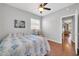 Bedroom featuring hardwood floors, ceiling fan, and bright window at 13534 W Young St, Surprise, AZ 85374