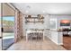 Inviting dining area with sliding glass doors and open shelving, creating a warm and welcoming atmosphere at 13534 W Young St, Surprise, AZ 85374