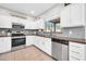 Modern kitchen with stainless steel appliances, stylish backsplash, and white cabinetry for a clean look at 13534 W Young St, Surprise, AZ 85374