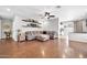 Spacious living room with hardwood floors, comfortable seating, and decorative shelving for a modern feel at 13534 W Young St, Surprise, AZ 85374