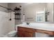 Bathroom featuring modern fixtures, sleek shower, and wood shelving for storage at 141 W Jamaica Pl, Casa Grande, AZ 85122