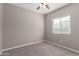 Bedroom with carpeted floors, a ceiling fan, and a bright window with blinds at 141 W Jamaica Pl, Casa Grande, AZ 85122