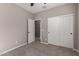 This bedroom has carpet flooring, neutral-colored walls, and a closet with white doors at 141 W Jamaica Pl, Casa Grande, AZ 85122