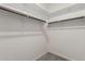 Walk-in closet featuring carpeted floors and built-in wood shelving for storage at 141 W Jamaica Pl, Casa Grande, AZ 85122