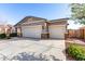 Attractive single-story home featuring a three-car garage, desert landscaping, and stone accents at 141 W Jamaica Pl, Casa Grande, AZ 85122